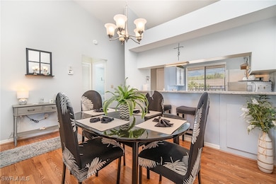 Dining space with a chandelier, high vaulted ceili