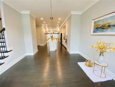Unfurnished living room featuring a chandelier, crown molding, stairway, dark wood finished floors, and recessed lighting