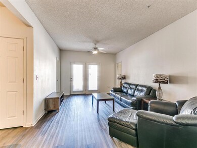 Living area featuring a textured ceiling, ceiling 