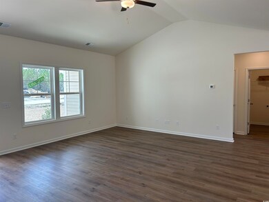 Spare room featuring visible vents, ceiling fan, d
