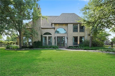 French provincial home featuring brick siding, fre