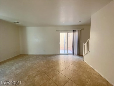 Empty room featuring tile patterned flooring, stai