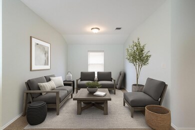 Carpeted living room featuring baseboards