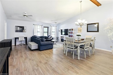 Dining area with baseboards, lofted ceiling with b