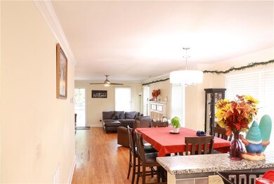 Dining space featuring ornamental molding, light wood-style flooring, and ceiling fan