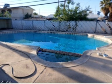 View of pool featuring a pool with connected hot t