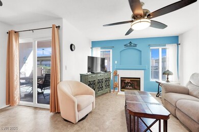 Living room with a ceiling fan and a tile fireplac