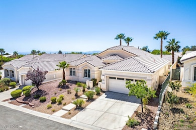 View of front facade with an attached garage, a ti