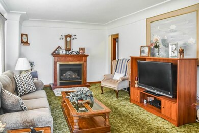 Step into the spacious living room with crown mold