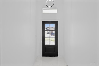 Doorway with marble finish floor and baseboards