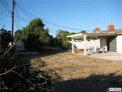 Another angle of the backyard showing patio cover