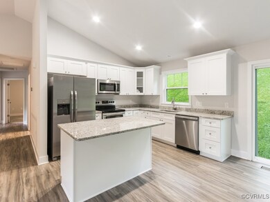 Kitchen with stainless steel appliances, sink, lig