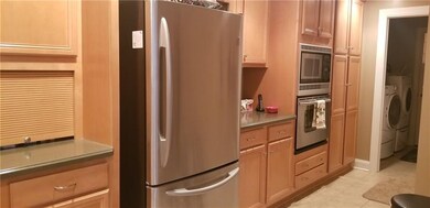 Kitchen leading to first floor laundry and garage