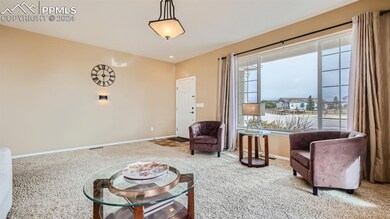 Living area featuring light carpet