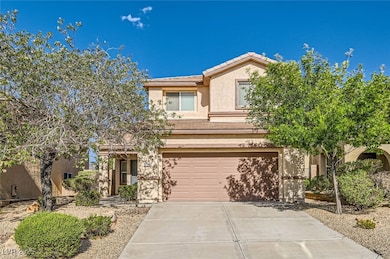 View of front of property featuring a garage, a ti