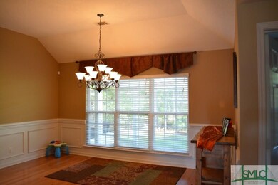 Dining room with chandelier and hardwood floors