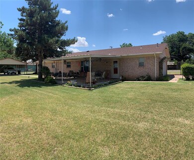 Rear view of property featuring a yard