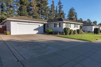 Angled front perspective highlighting the clean walkway and generous front yard space.