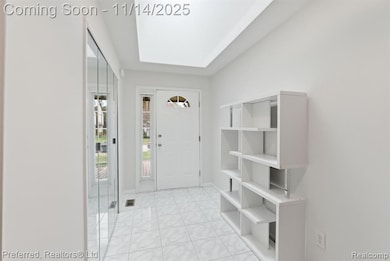Entryway featuring light tile patterned floors and baseboards