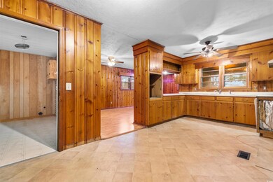 Kitchen with light countertops, brown cabinetry, w