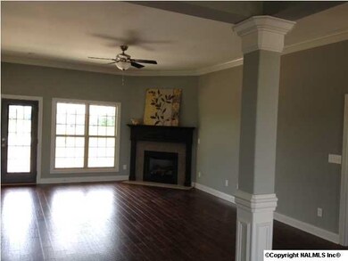A view of the back of the great room. Double windows and a French door make way for a beautiful view of the private lake/pond backing up to this beautiful full brick home. Large covered back porch makes a great place to have your early morning coffee or r
