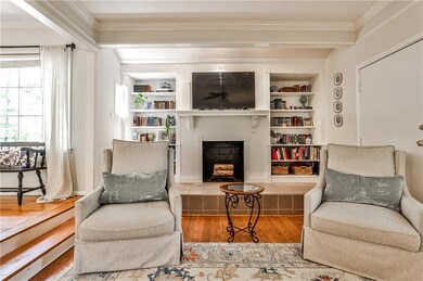 Elegant fireplace with a raised hearth, providing a warm focal point and architectural charm to the living space