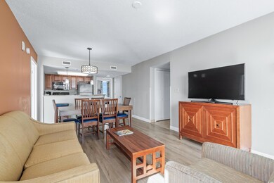Living area with visible vents, light wood-style f