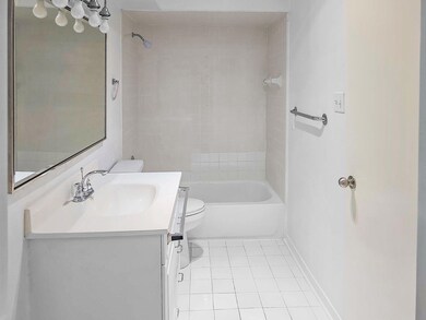 Bathroom featuring vanity, baseboards, shower / tu