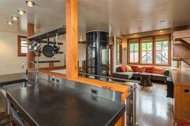 UPPER LEVEL LIVING AREA OPENS TO PATIO AND SKI ARE