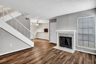 Living room featuring fireplace, and vinyl plank f