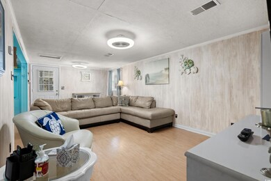 Living room with crown molding, hardwood / wood-st