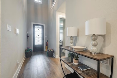 Entrance foyer featuring hardwood / wood-style flo