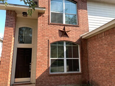 View of exterior entry with brick siding