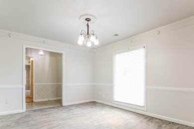 Unfurnished room featuring plenty of natural light