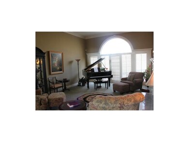 Great Room with plantation shutters overlooks back