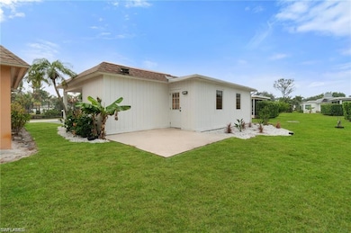 Rear view of property featuring a patio and a lawn