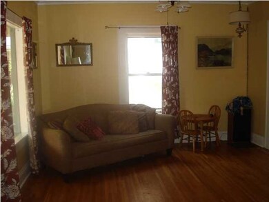 Other side of living room just inside the front do