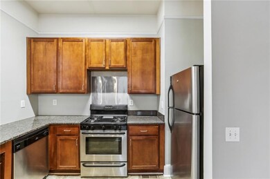 Kitchen featuring stainless steel appliances and brown cabinetry