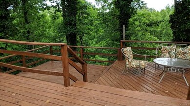Private rear deck with view of woodland area.