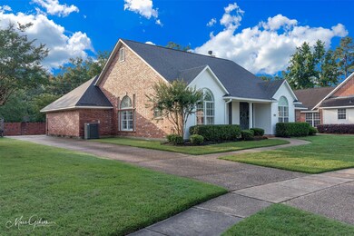 View of front of home featuring a front lawn and c