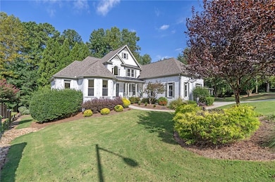 View of front of house with a front yard and roof with shingles