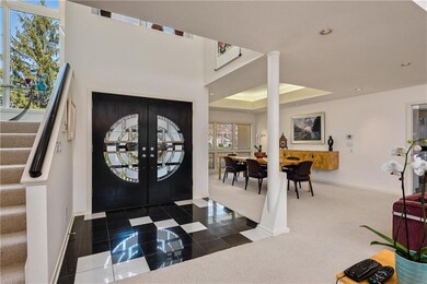 Custom-designed, artglass double doors open onto a