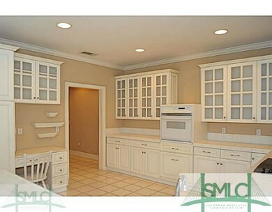 Kitchen. The large, crisp white kitchen is open to
