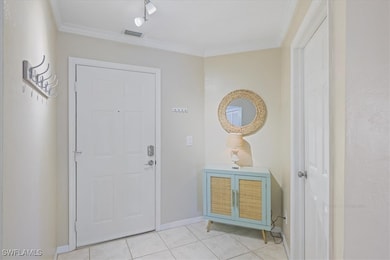 Foyer featuring light tile patterned flooring and
