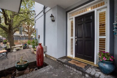 Solid brick patio to entry door with transom windo