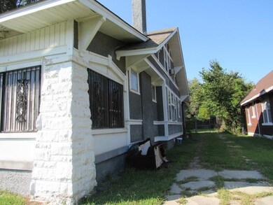 View of property exterior featuring a lawn