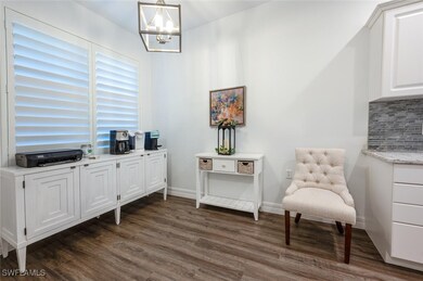 Sitting room featuring baseboards, a notable chand