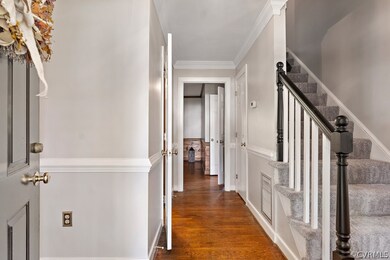 Entry with hardwood floors and fresh paint.