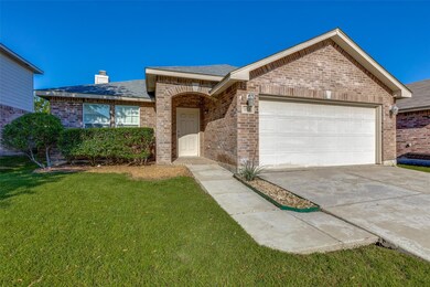 Ranch-style home featuring a front yard and a gara