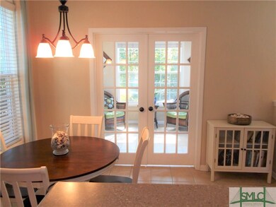 Beautiful French Doors lead to bright and airy Sun
